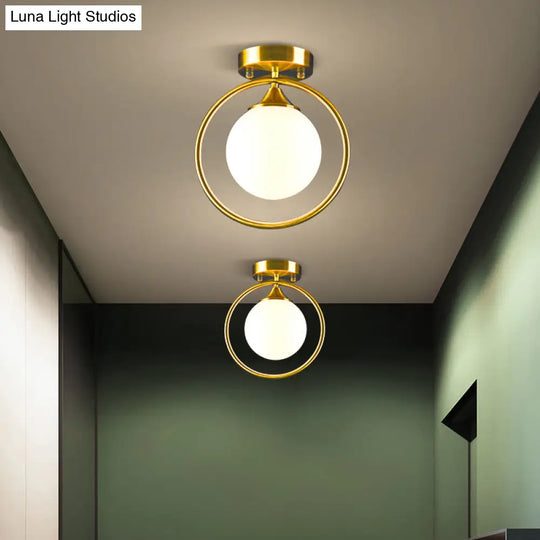 Postmodern Glass Ball Ceiling Light With Brass Metal Ring - 1-Light Semi-Flush Mount For Corridors