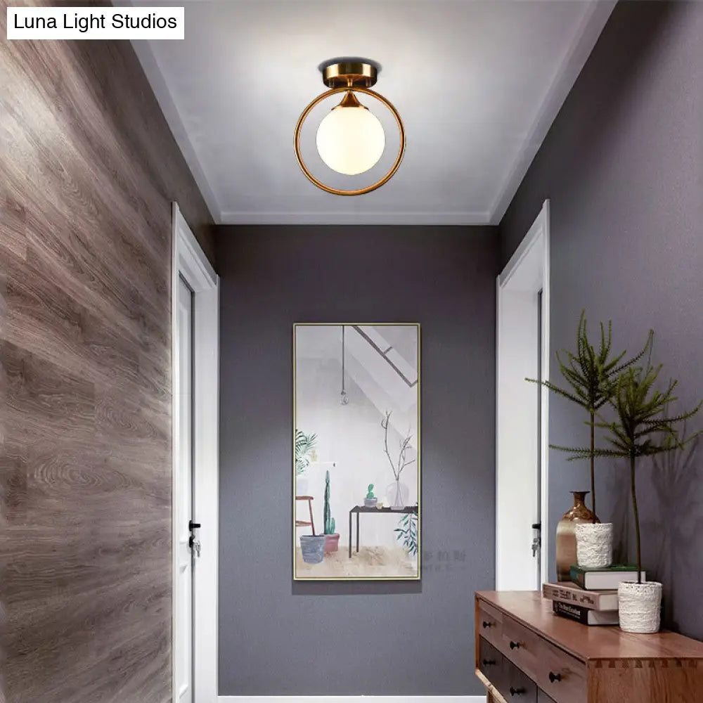 Postmodern Glass Ball Ceiling Light With Brass Metal Ring - 1-Light Semi-Flush Mount For Corridors