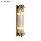 Postmodern Gold Wall Sconce With Clear Fluted Glass - 2 Lights Tubular Design