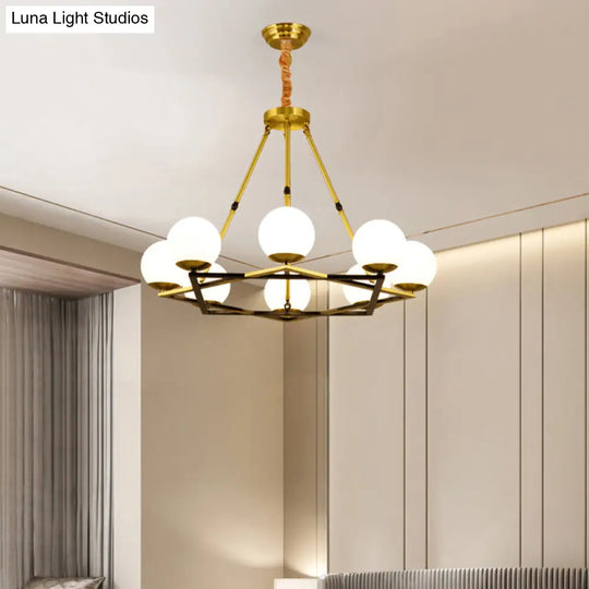 Postmodern Polygon Metal Chandelier With Brass Finish And Globe White Glass Shades