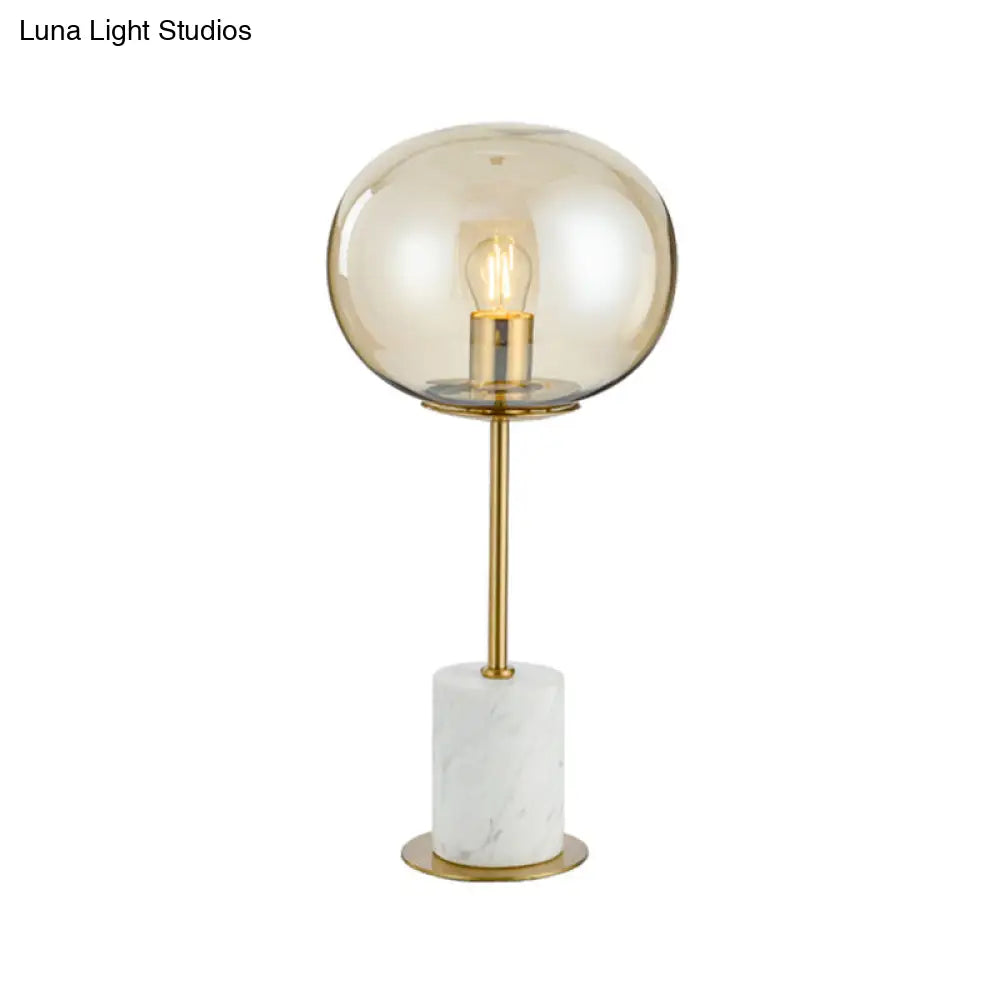 Clear Glass Night Light With Minimalist Oval Design Brass Accents And Marble Base