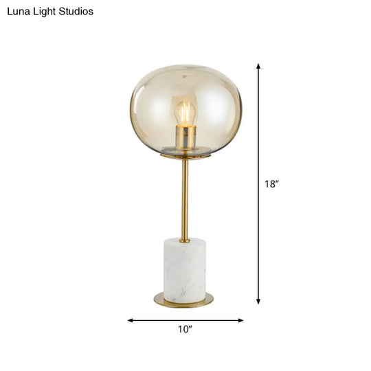 Clear Glass Night Light With Minimalist Oval Design Brass Accents And Marble Base