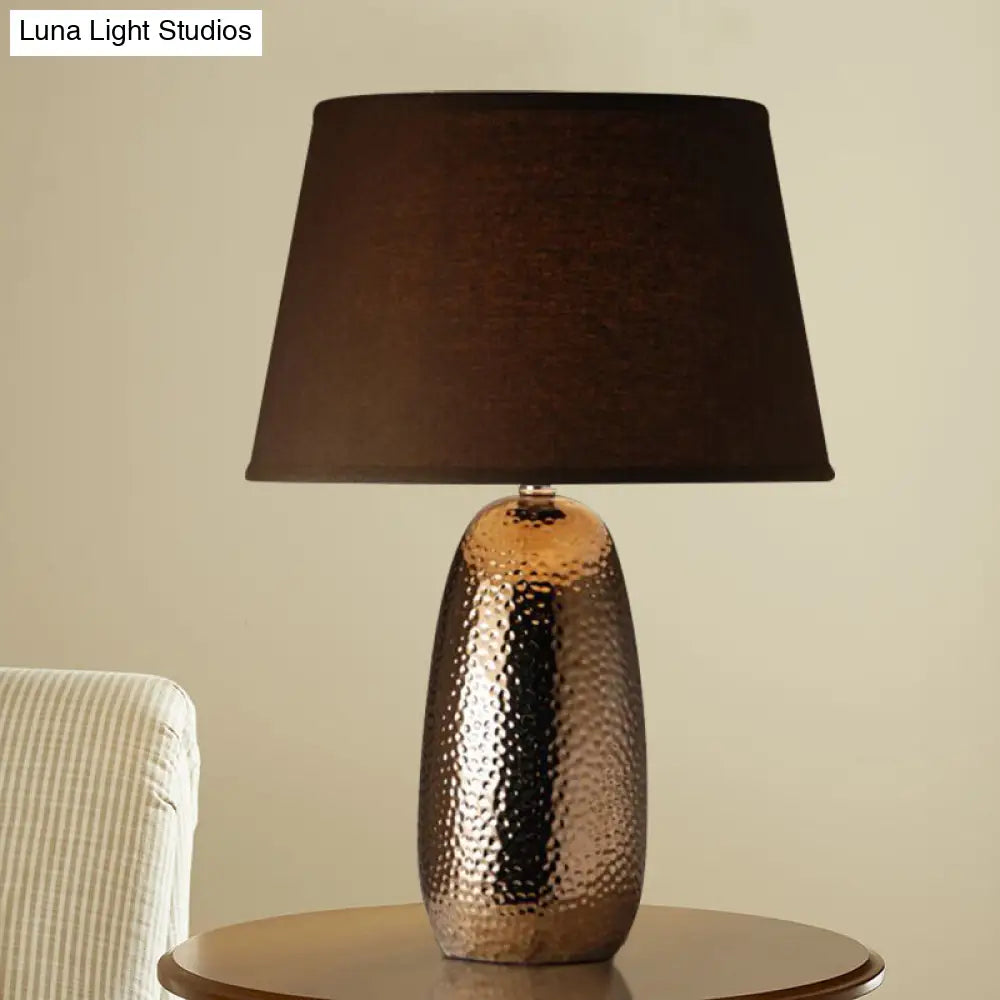 Rustic Hammered Ovoid Nightstand Lamp With Conical Fabric Shade In Brown For Bedroom