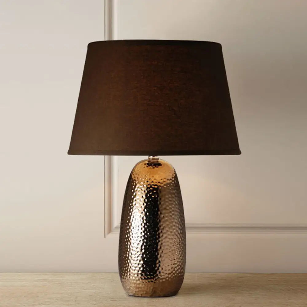 Rustic Hammered Ovoid Nightstand Lamp With Conical Fabric Shade In Brown For Bedroom