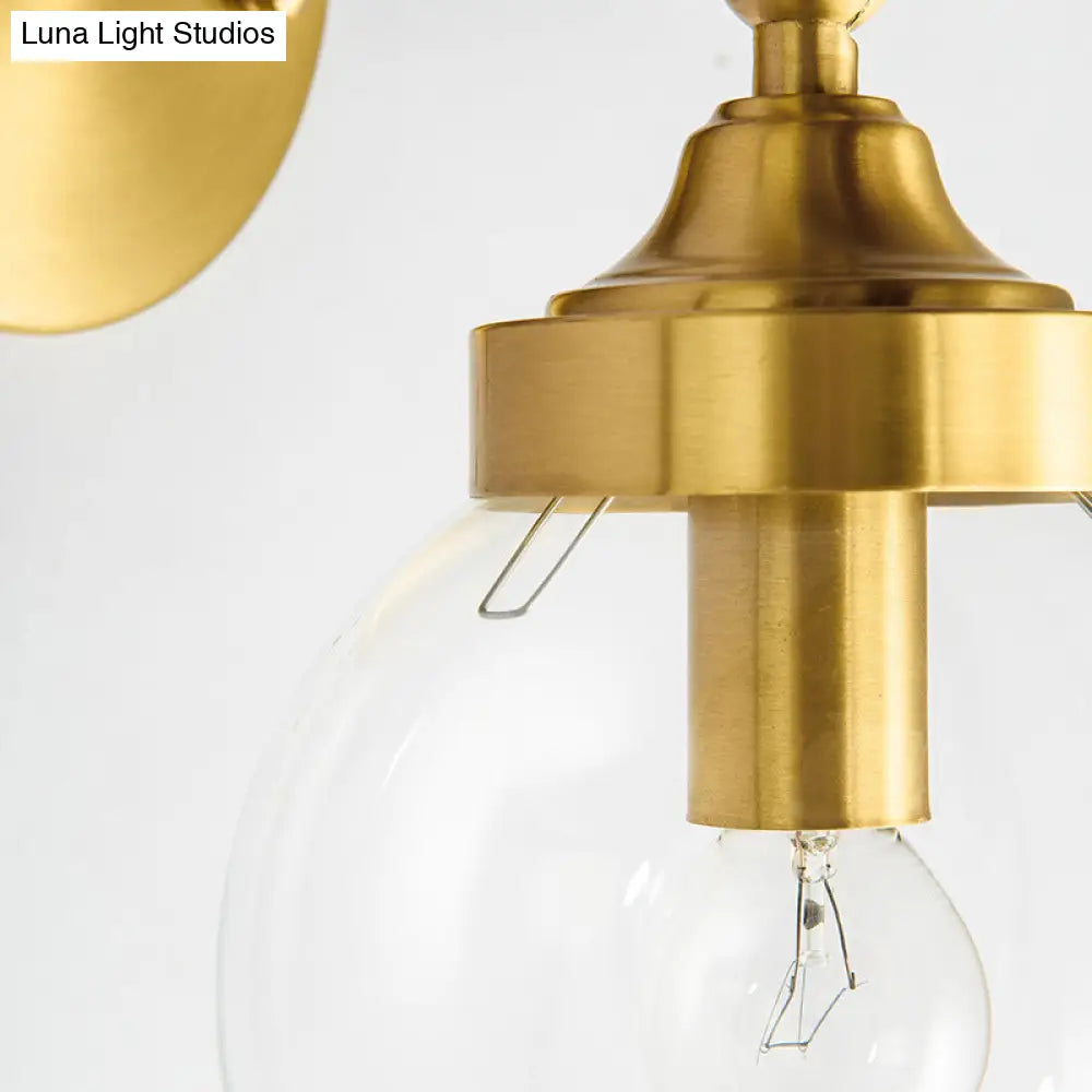 Simplicity Adjustable Globe Sconce Light Brass Wall Mount Lamp - 1 Bulb With Transparent Glass Shade