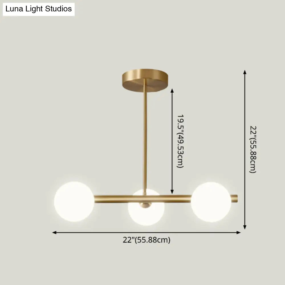 Sleek And Elegant Linear Gold Island Pendant Lighting With Spherical Glass Shades For Dining Table