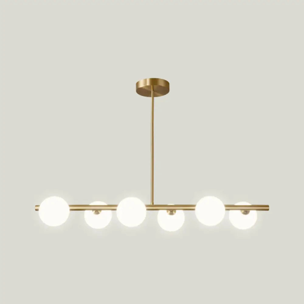 Sleek And Elegant Linear Gold Island Pendant Lighting With Spherical Glass Shades For Dining Table