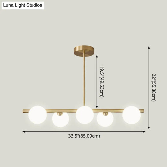 Sleek And Elegant Linear Gold Island Pendant Lighting With Spherical Glass Shades For Dining Table