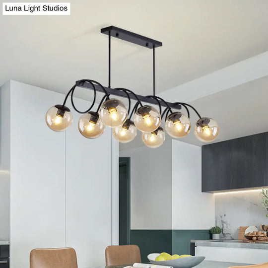 Sleek Black Glass Sphere Island Light For Modern Dining Rooms