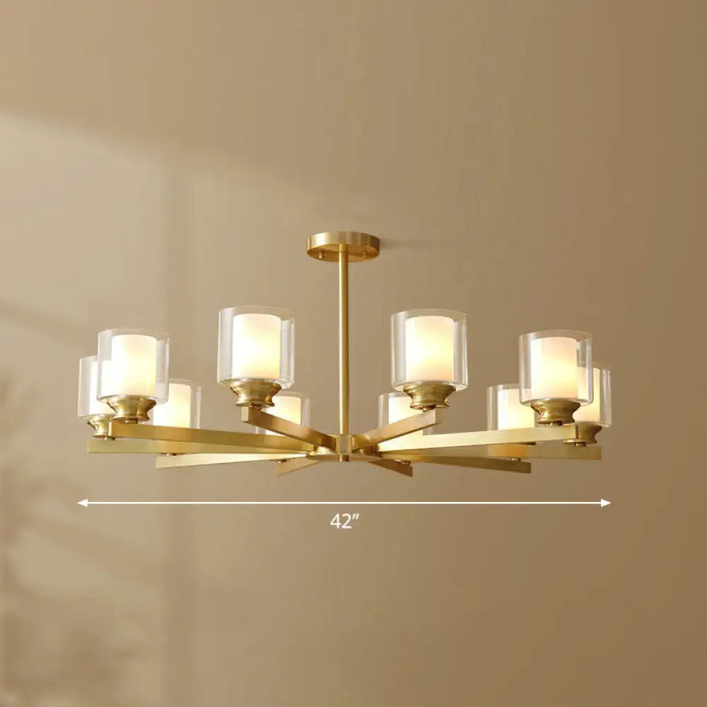 Sleek Brass Cylindrical Hanging Lamp With Clear And Frosted Glass Minimalistic Dining Room