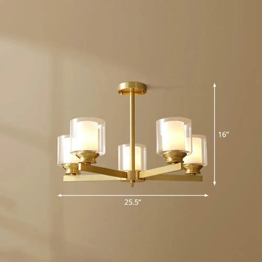 Sleek Brass Cylindrical Hanging Lamp With Clear And Frosted Glass Minimalistic Dining Room