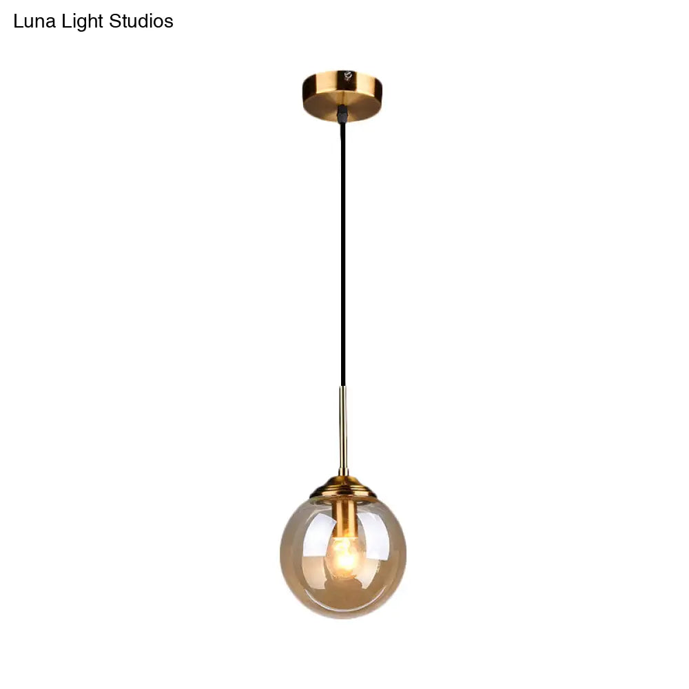 Sleek Brass Pendant Lamp With Amber/Smoke Glass Shade – Perfect For Dining Room Ceilings