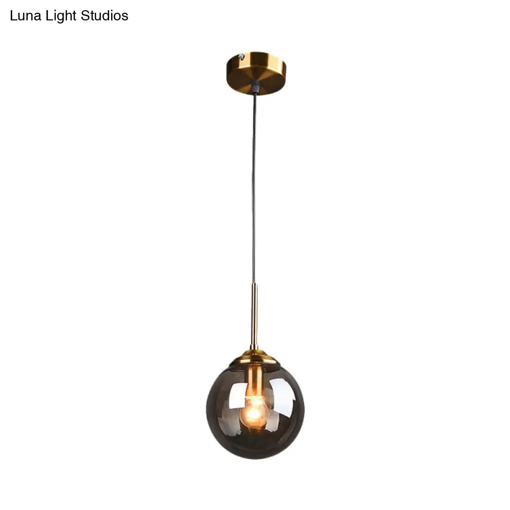 Sleek Brass Pendant Lamp With Amber/Smoke Glass Shade – Perfect For Dining Room Ceilings