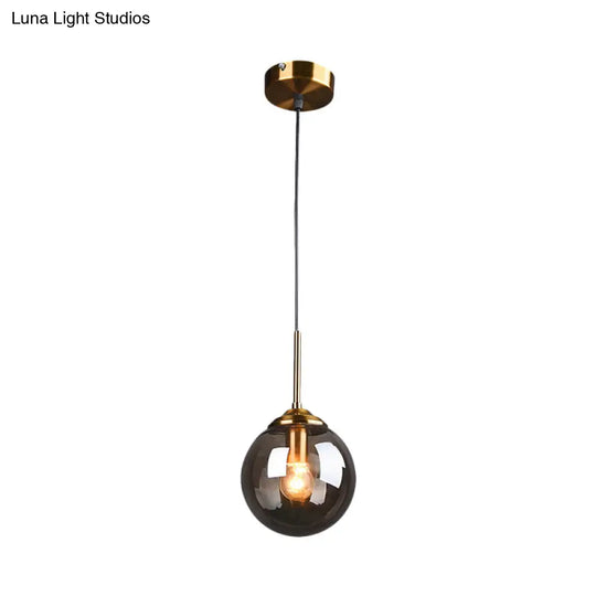 Sleek Brass Pendant Lamp With Amber/Smoke Glass Shade – Perfect For Dining Room Ceilings