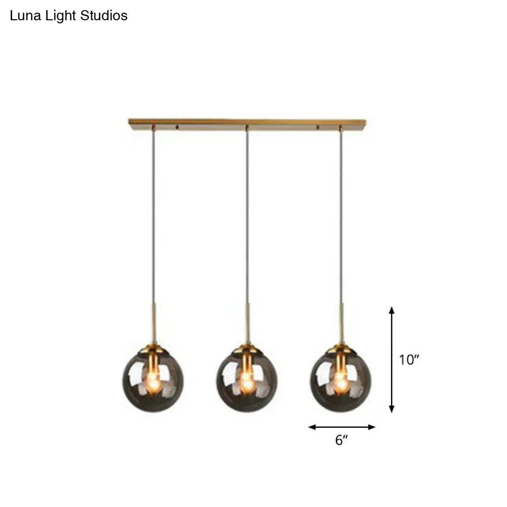 Sleek Glass 3-Bulb Spherical Ceiling Light Fixture In Brass For Minimalistic Dining Rooms