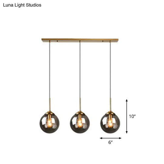 Sleek Glass 3-Bulb Spherical Ceiling Light Fixture In Brass For Minimalistic Dining Rooms