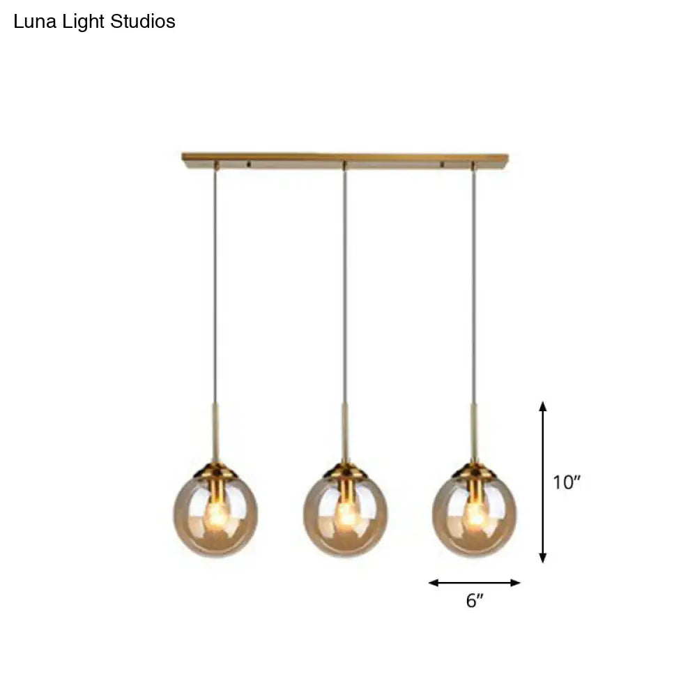 Sleek Glass 3-Bulb Spherical Ceiling Light Fixture In Brass For Minimalistic Dining Rooms