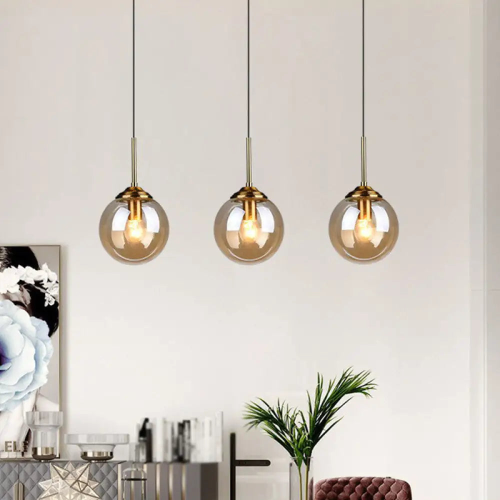 Sleek Glass 3-Bulb Brass Suspension Pendant Light For Minimalistic Dining Room Decor Amber