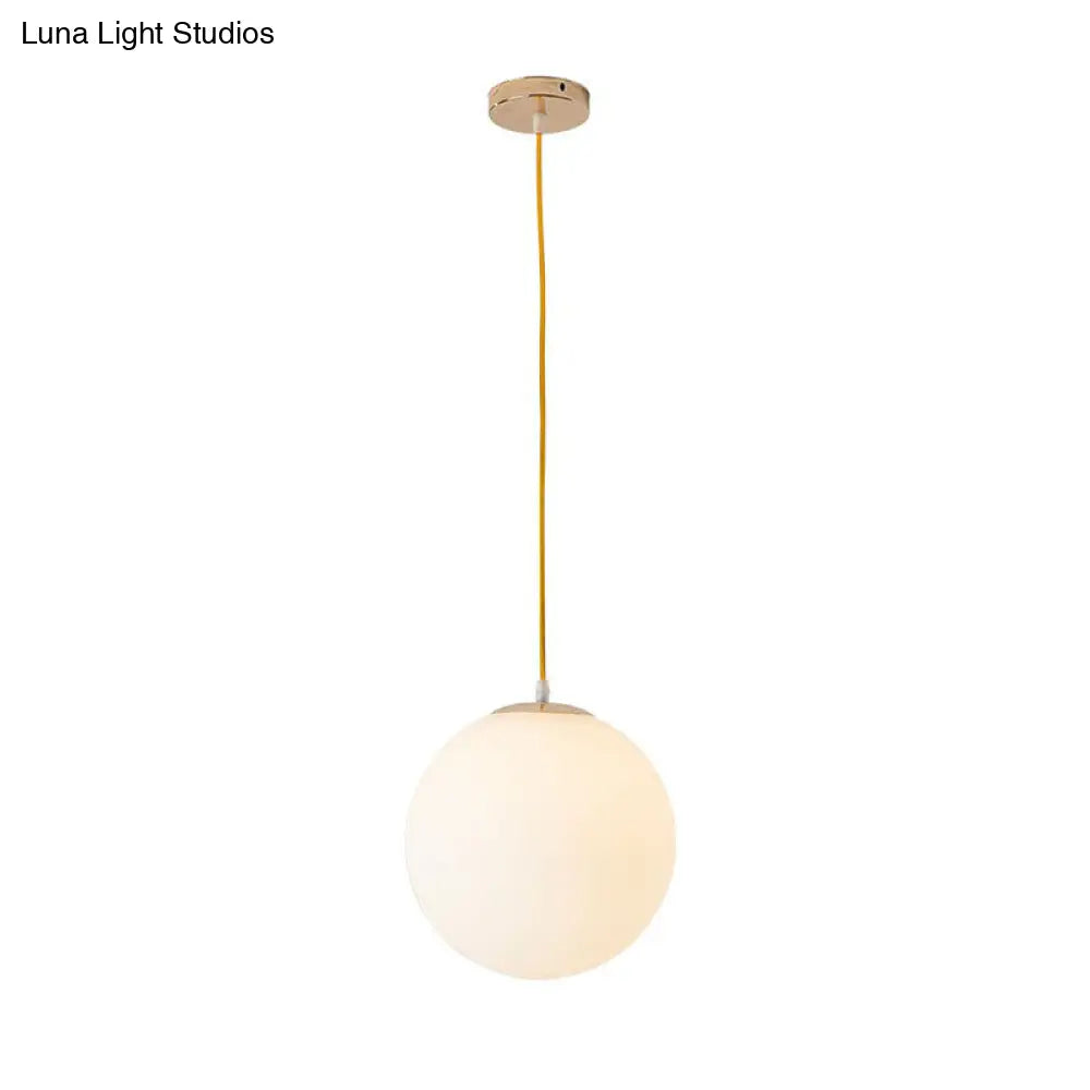 Sleek White Glass Pendant Light For Minimalist Table Settings