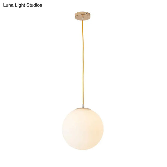 Sleek White Glass Pendant Light For Minimalist Table Settings