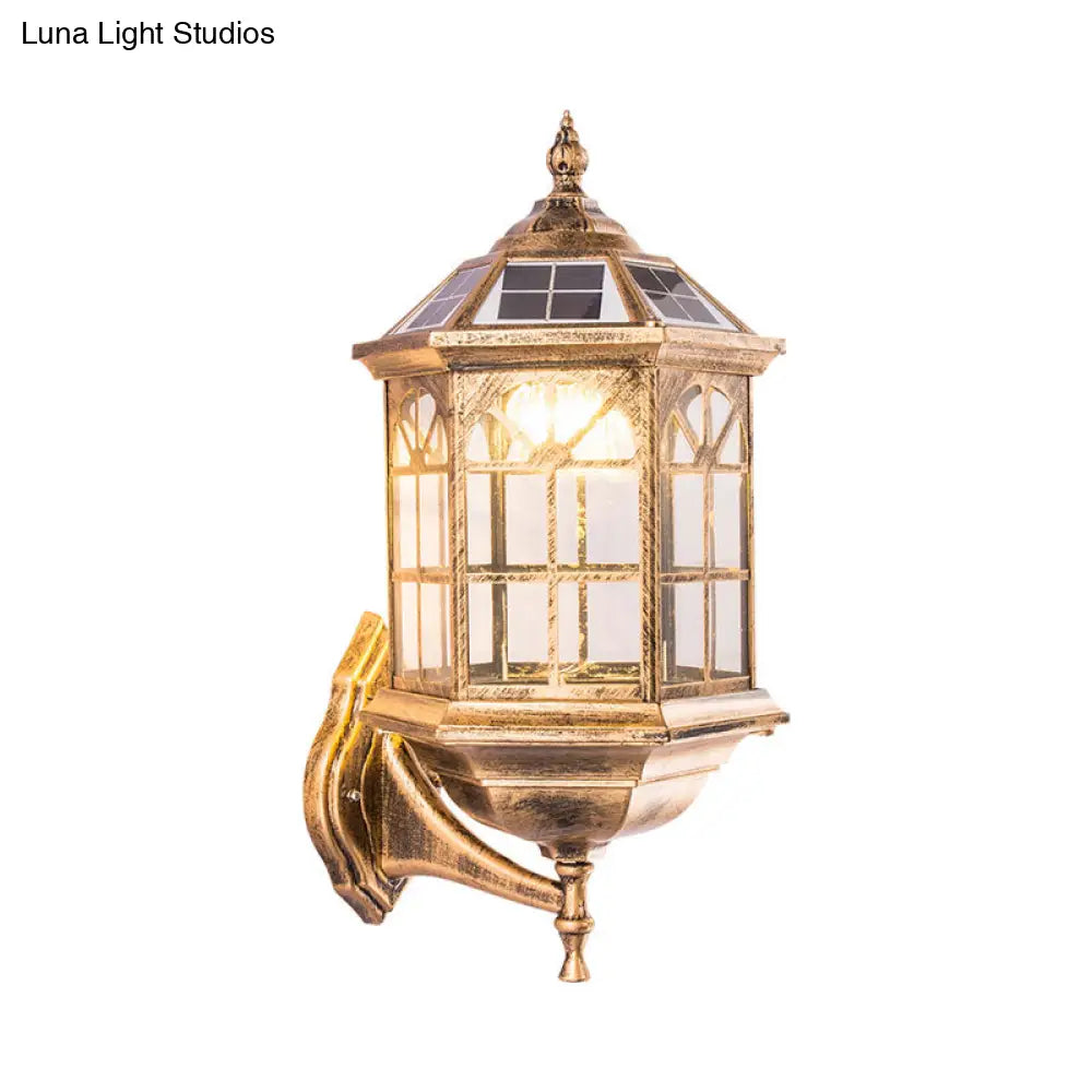 Traditional Outdoor Solar Wall Light Fixture With Metallic House Shaped Design And Clear Glass Shade