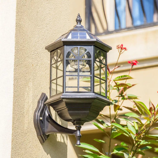 Traditional Outdoor Solar Wall Light Fixture With Metallic House Shaped Design And Clear Glass Shade