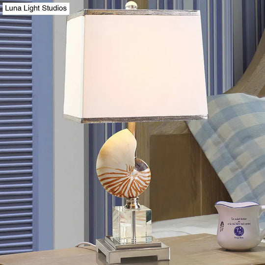 White Fabric Cuboid Nightstand Lamp With Decorative Nautilus Shell Accent - 1 Head Night Table Light