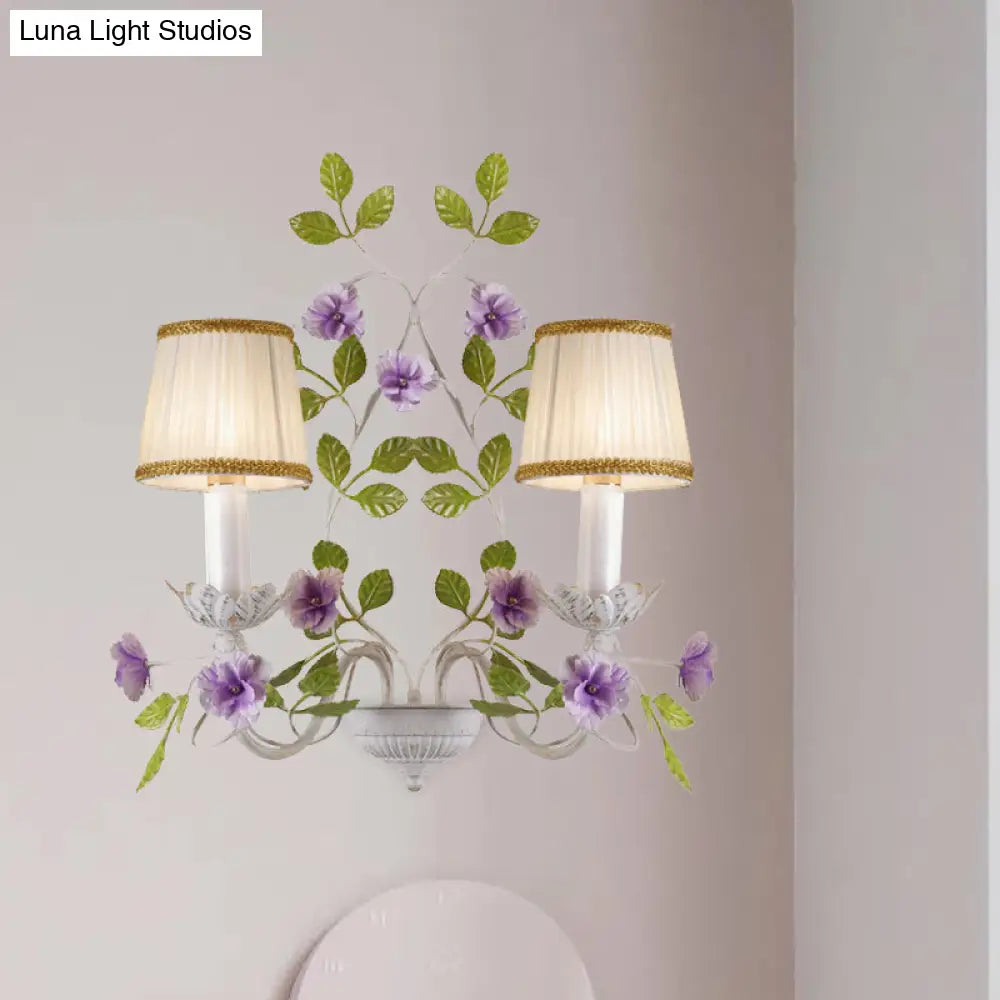 White Wall Sconce With Purple Flower Design And Pleated Shade For Bedroom Decor