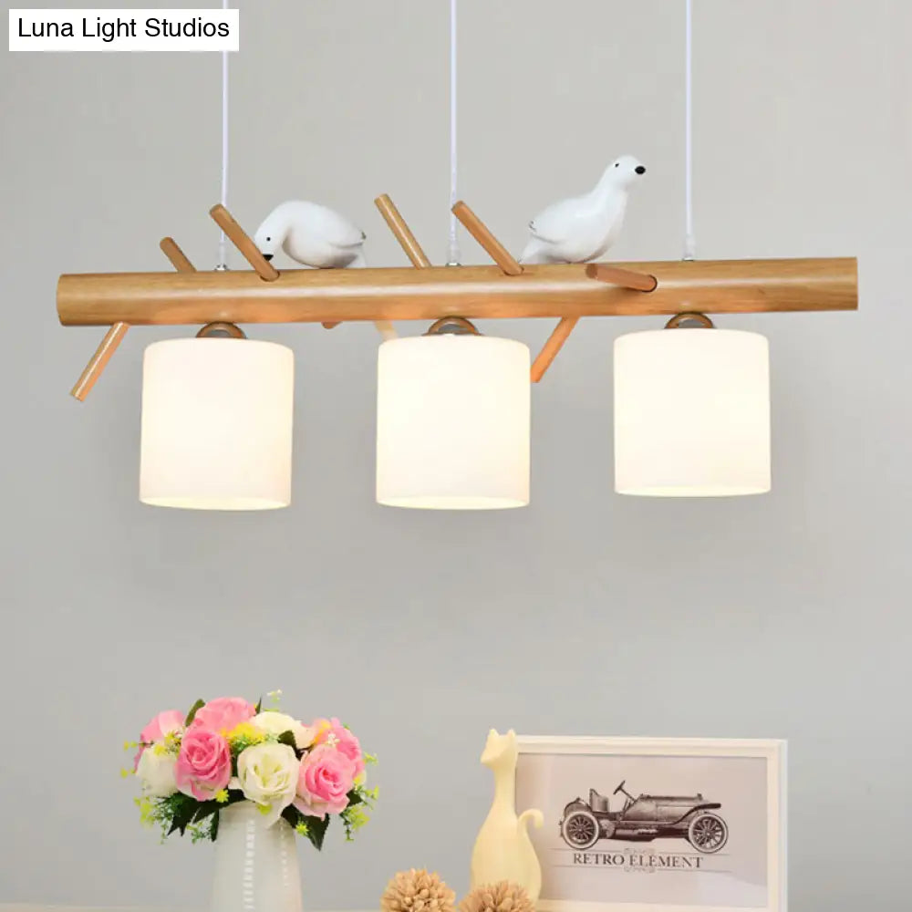 Wooden Hanging Chandelier With 2/3 Lights Glass Cylinder Shade And Bird Décor - Ideal For Dining